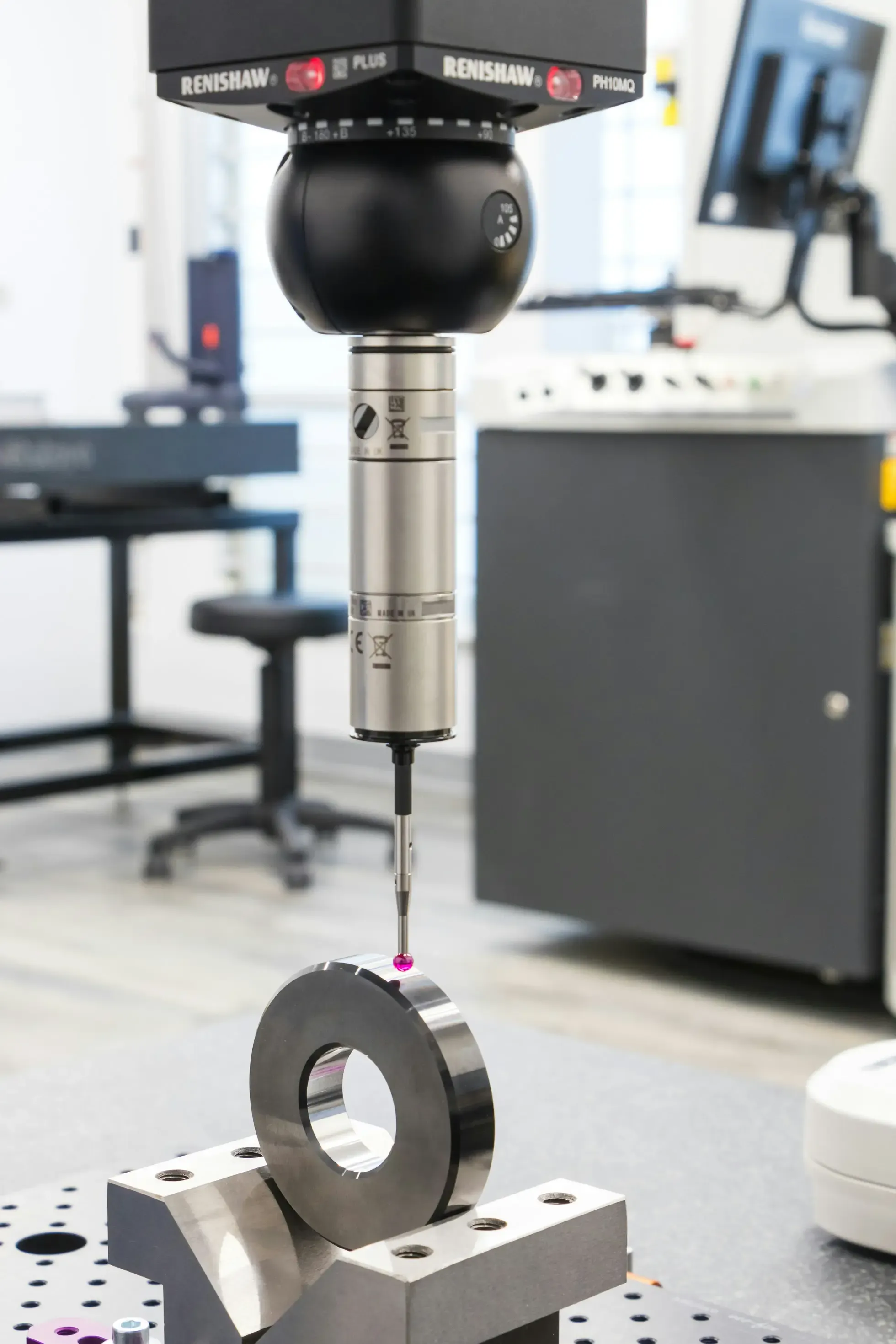 Coordinate measuring machine with ruby probe inspecting workpiece